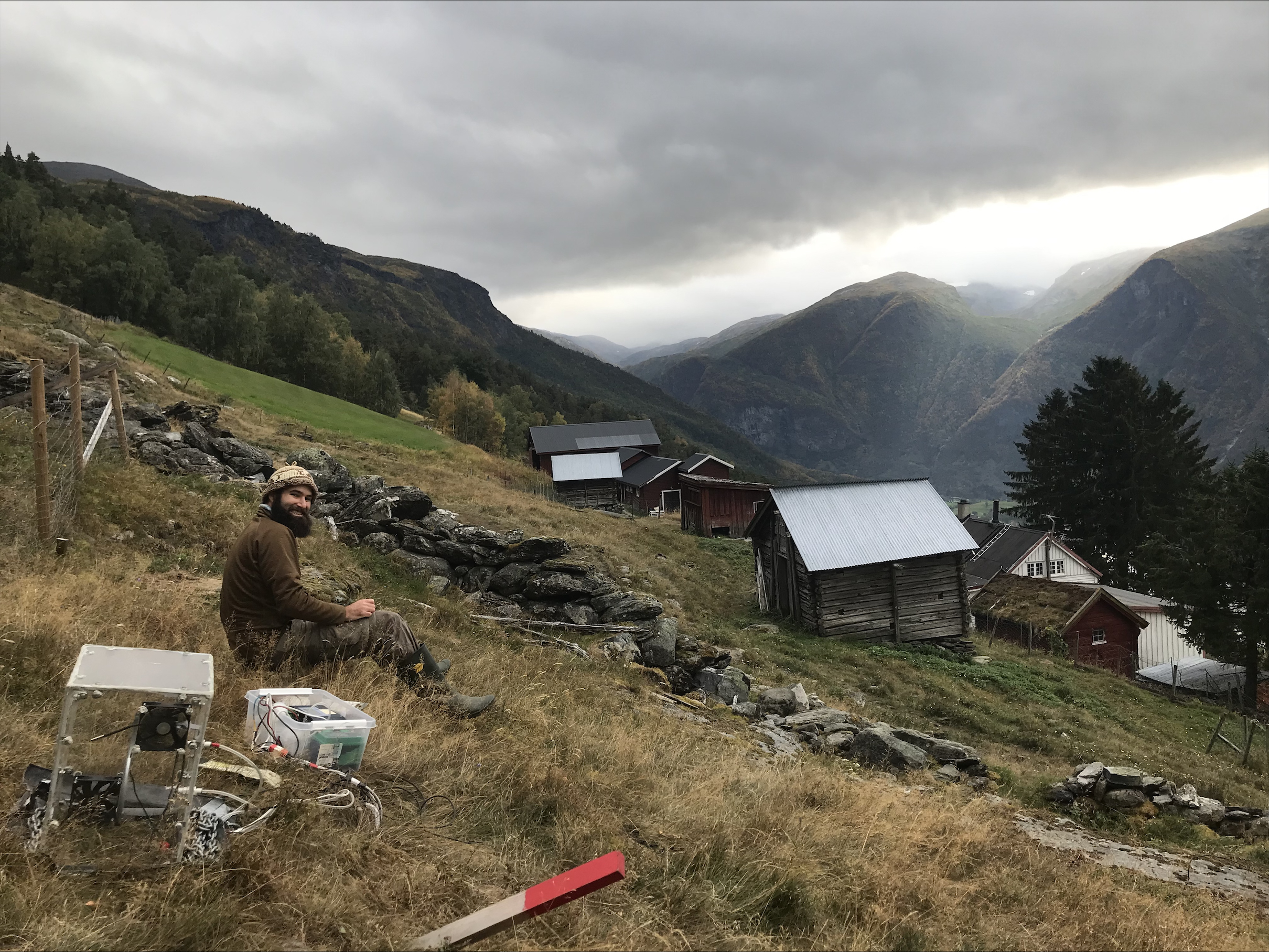 researcher in the mountains, steep hillside