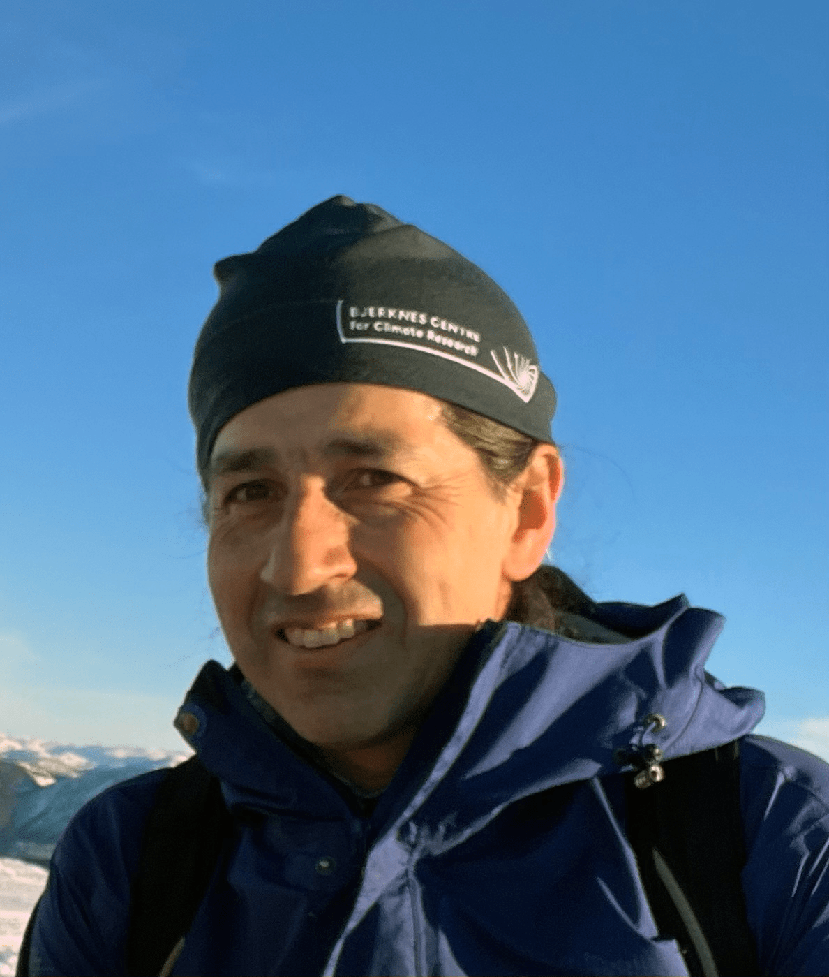 Profile photo of scientist wearing a woolen cap with the Bjerknes Center logo.